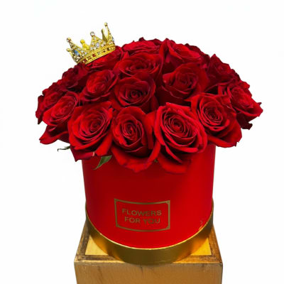 Red roses in a red hat box with a small gold crown