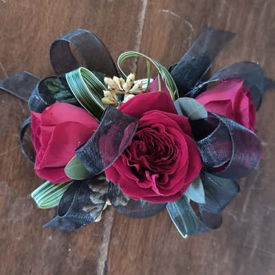 Small bouquet of deep pink roses with black ribbon loops