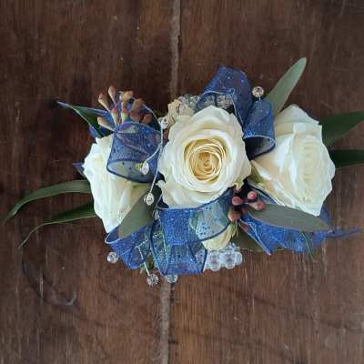 White rose bouquet with blue ribbon and small crystal accents
