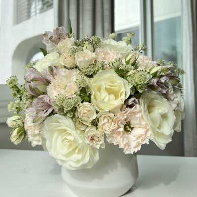 Cream and blush bouquet in a white vase