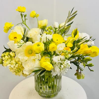 Yellow and white mixed bouquet in a clear glass vase