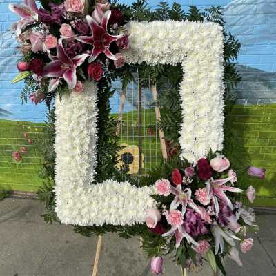 Large floral number-shaped arrangement with white and pink flowers