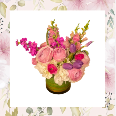 Pink and purple mixed flower arrangement in a green vase
