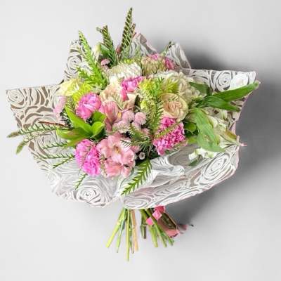 Pink and white mixed bouquet wrapped in patterned paper