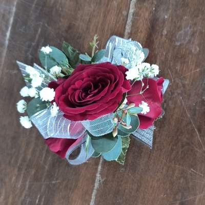 Small bouquet of red roses with white filler flowers and silver ribbon