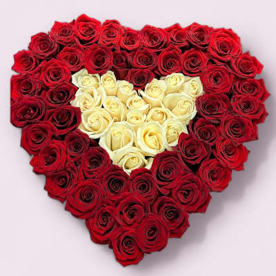 Heart-shaped arrangement of red and white roses