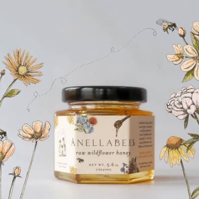 Jar of raw wildflower honey with floral label art