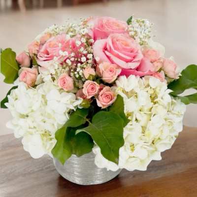 Pink roses and white hydrangeas in a silver vase