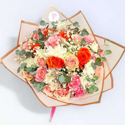Bouquet of pink and orange roses with white flowers and eucalyptus
