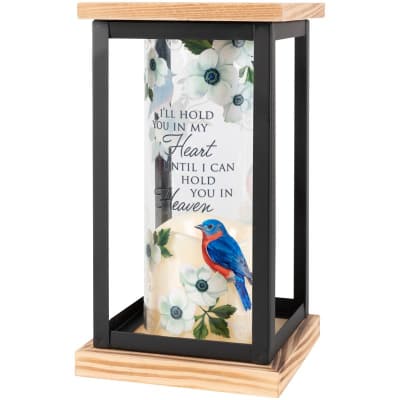 Memorial lantern with white floral print, bluebird, and remembrance quote around a candle