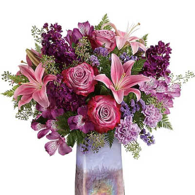 Pink and purple flower arrangement in a tall iridescent vase