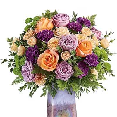 Mixed bouquet of roses and purple blooms in a tall iridescent vase