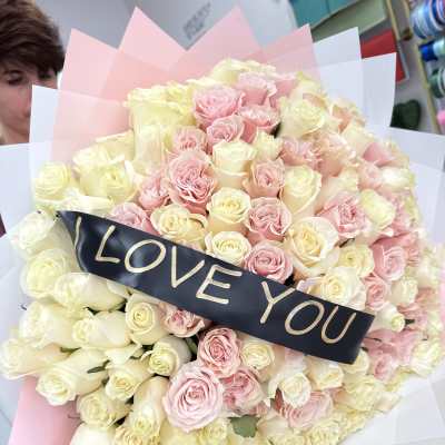 Large bouquet of pink and cream roses with a "LOVE YOU" ribbon
