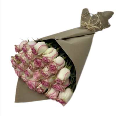 Bouquet of pink-edged white roses wrapped in brown paper
