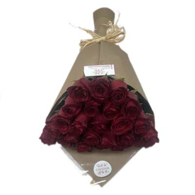 Bouquet of deep red roses wrapped in brown paper