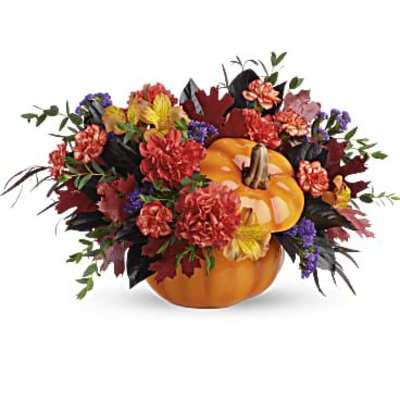 Autumn floral arrangement with pumpkins and mixed flowers