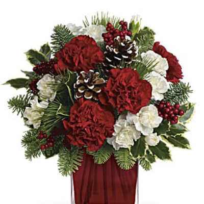 Red and white floral arrangement in a clear square vase