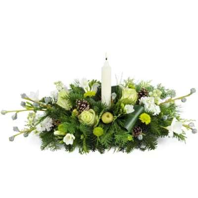 Low floral centerpiece with a white candle and white blooms