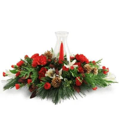 Red carnations and pine arranged around a red taper candle in a glass hurricane