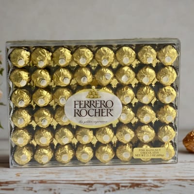 Box of Ferrero Rocher chocolates beside a small potted flower arrangement