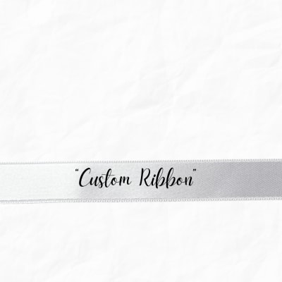 White ribbon with the words "Custom Ribbon" printed on it