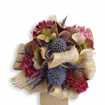 Bouquet of pink and blue flowers wrapped in burlap ribbon