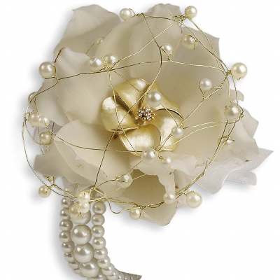 White floral corsage with pearl accents and gold wire