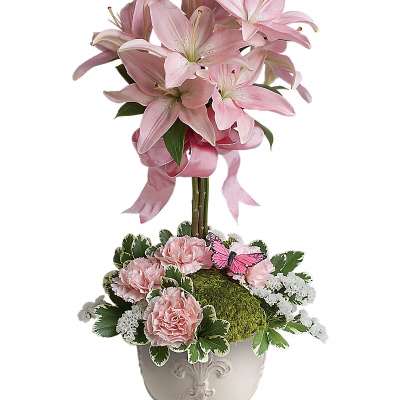 Pink lilies and carnations in a white pedestal vase with a butterfly accent