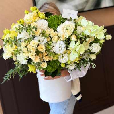 Large bouquet of white, cream, and pale green flowers