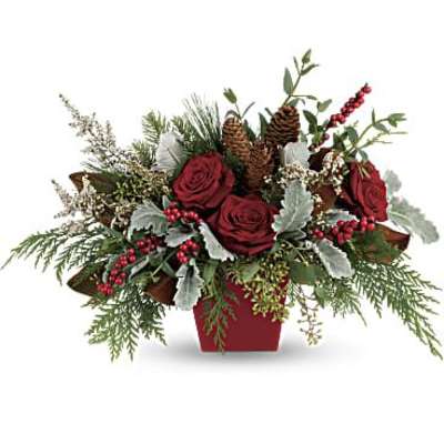 Red roses in a red container with pinecones and berries