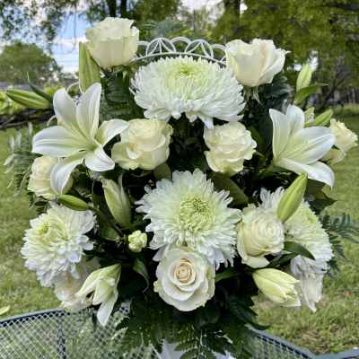 White roses, lilies, and chrysanthemums in a white vase