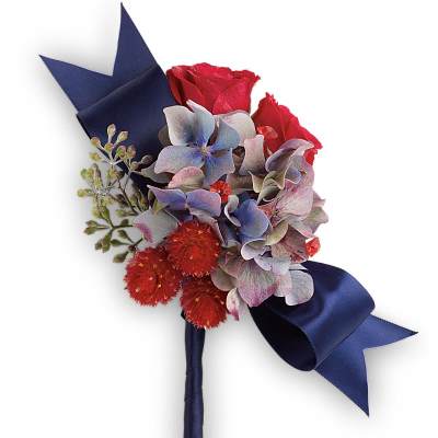 Boutonniere with red roses, blue hydrangea, and navy ribbon