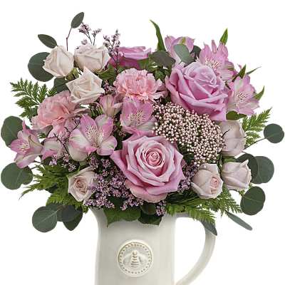 Pink and cream bouquet in a white ceramic mug vase