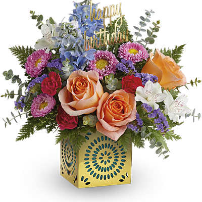 Mixed bouquet with roses, daisies, and a birthday topper in a gold vase