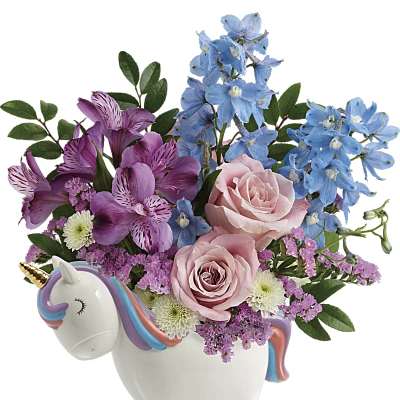 Pink and blue flowers arranged in a unicorn-shaped ceramic container