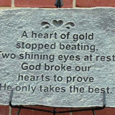 Engraved memorial stone with a poem on a metal stand