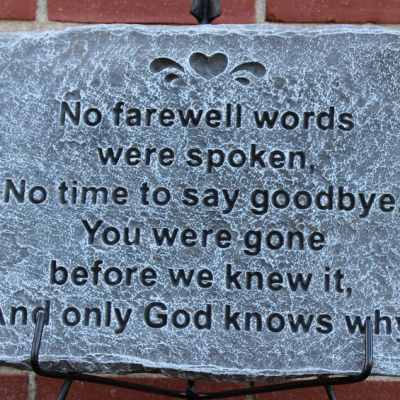 Memorial stone plaque with an engraved sympathy message