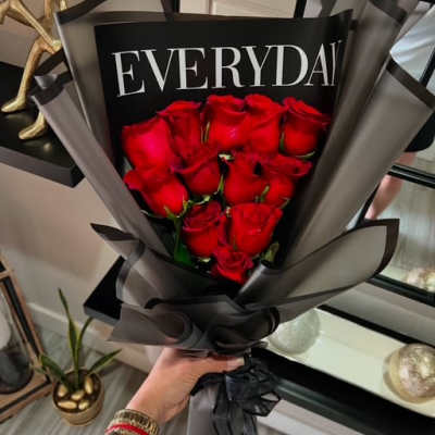 Bouquet of red roses wrapped in black and gray paper