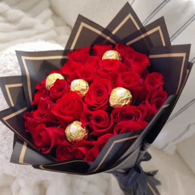 Bouquet of red roses with gold-wrapped chocolates in black paper