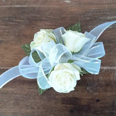 White rose corsage with a pale blue ribbon