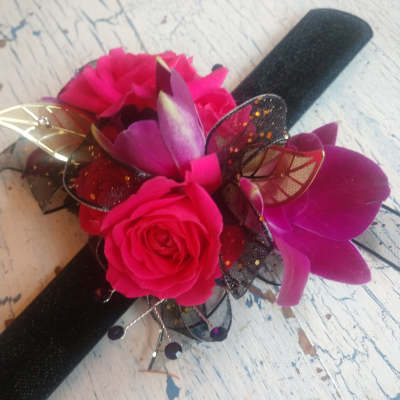 Pink rose corsage with black ribbon and decorative mesh accents