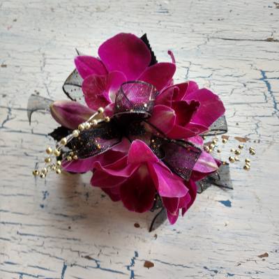 Magenta orchid corsage with black ribbon and gold bead accents