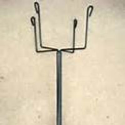 Metal plant stand with a tall central pole and four wire arms