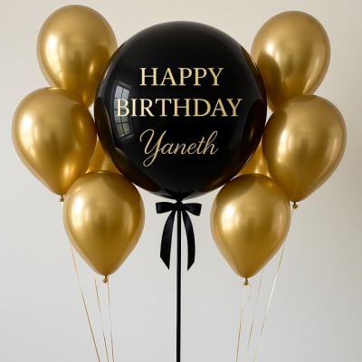 Black birthday balloon with gold balloons and a ribbon