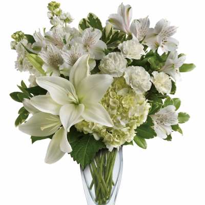 White lilies and alstroemeria in a clear glass vase