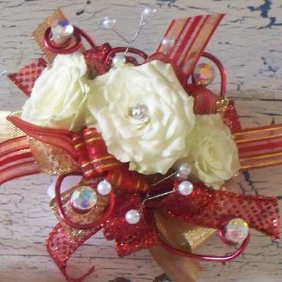 Small bouquet of white roses with red ribbon and jeweled accents