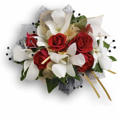 Red roses and white orchids arranged with gold ribbon and black mesh