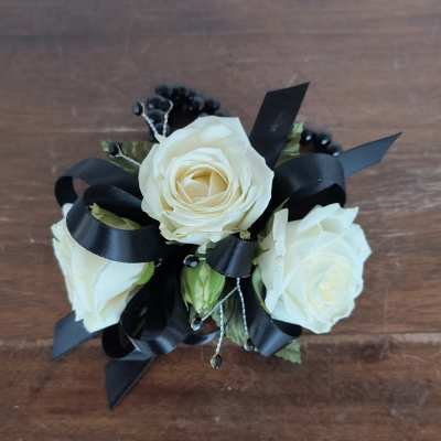 White rose corsage with black ribbon and bead accents