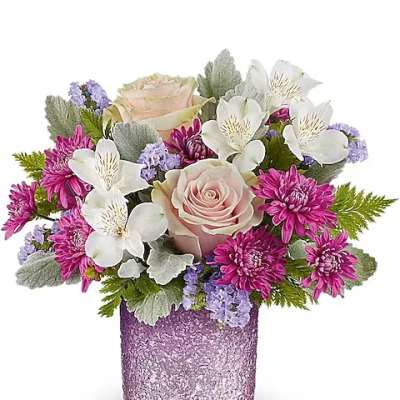Short arrangement of pink roses, white alstroemeria and purple mums in a textured lavender glass vase
