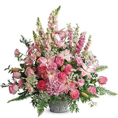 Pink lilies and roses arranged in a gray vase